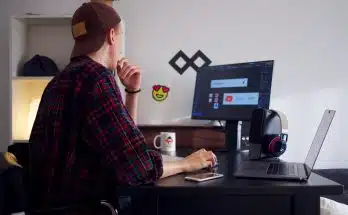 man sitting near table using computer