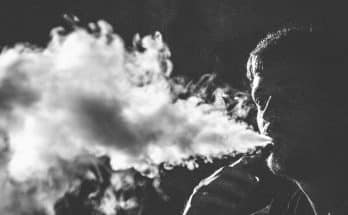grayscale photography of smoking man